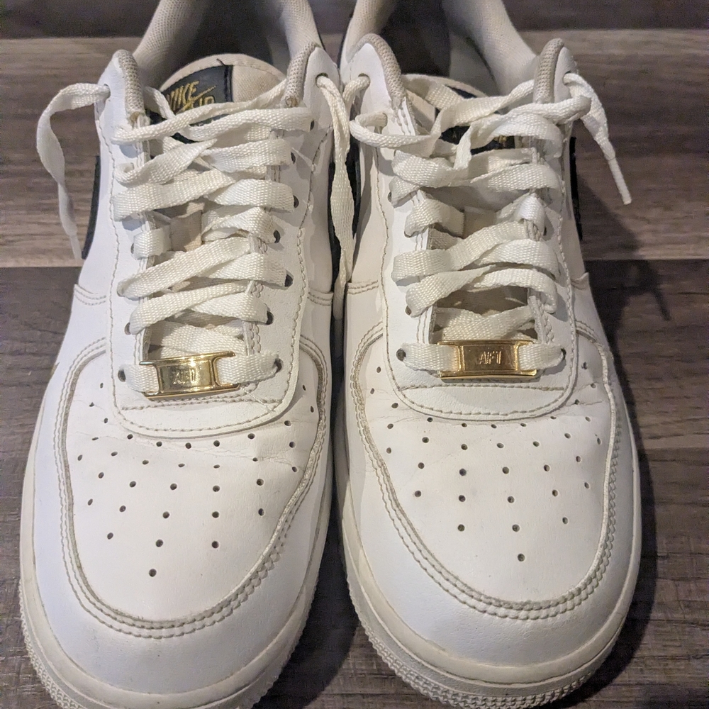 Nike White Sneakers with Gold Accents